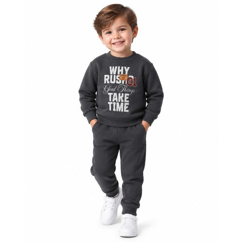 Young boy wearing a grey sweatshirt and joggers 