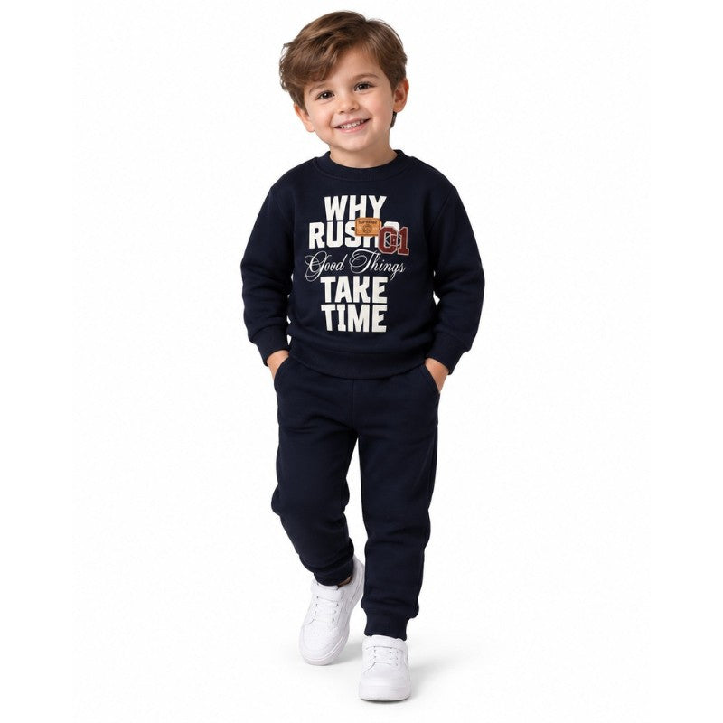 Young boy wearing a navy sweatshirt and joggers 