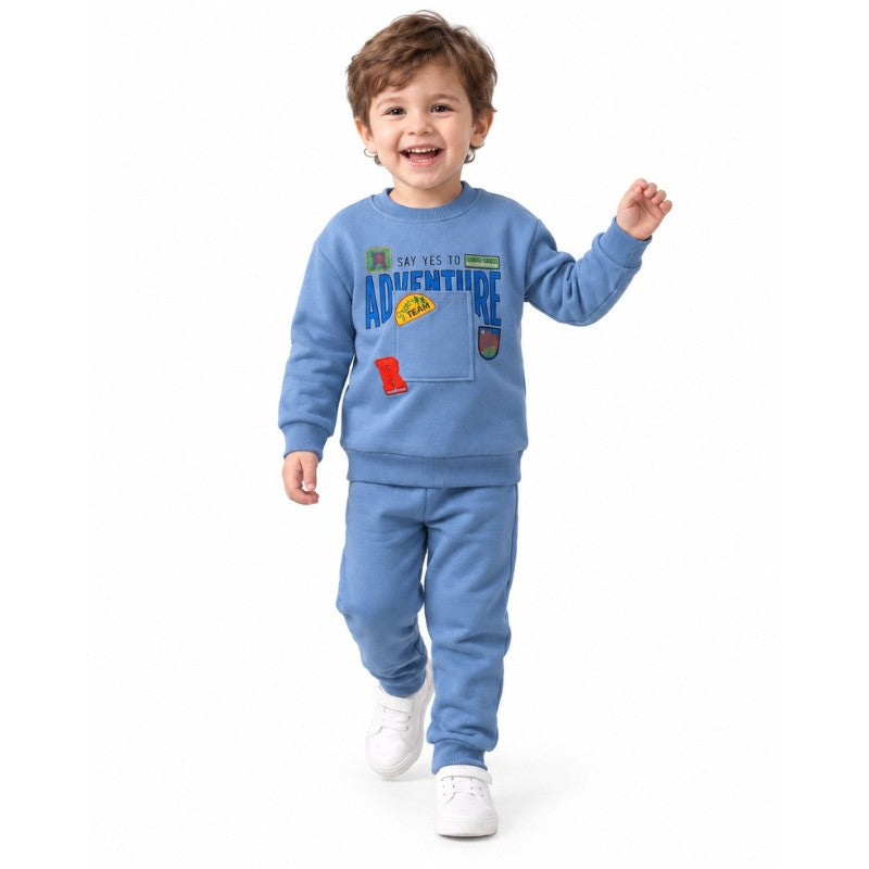 Young boy wearing a blue adventure sweatshirt 