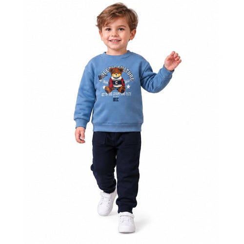 Young boy wearing a light blue teddy bear sweatshirt and navy pants