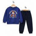 Young boy wearing a blue teddy bear sweatshirt and navy pants 