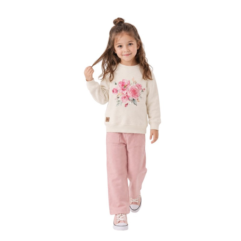 Girl wearing a cream floral sweatshirt with wide-leg pants 