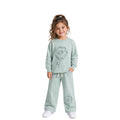 Young girl wearing a mint green floral tracksuit 