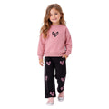 Young girl wearing a sweatshirt with a heart graphic and jogger pants featuring pink heart prints, stylish children's two-piece outfit.