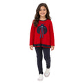 Young girl wearing a red ladybug tunic with navy polka-dot leggings.
