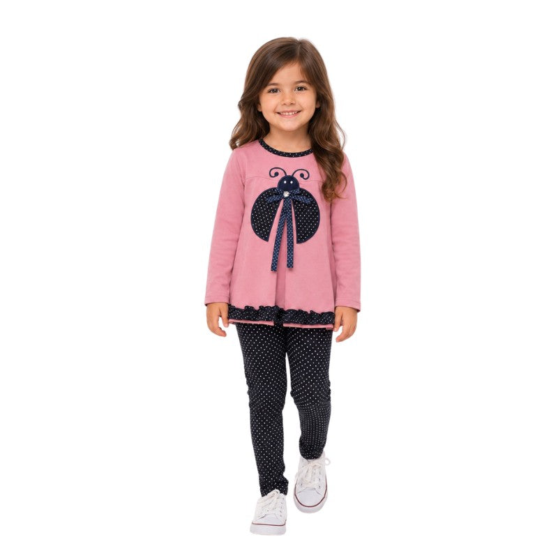 Young girl wearing a pink ladybug tunic with navy polka-dot leggings 
