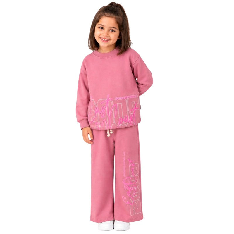 Young girl wearing a graphic tracksuit set