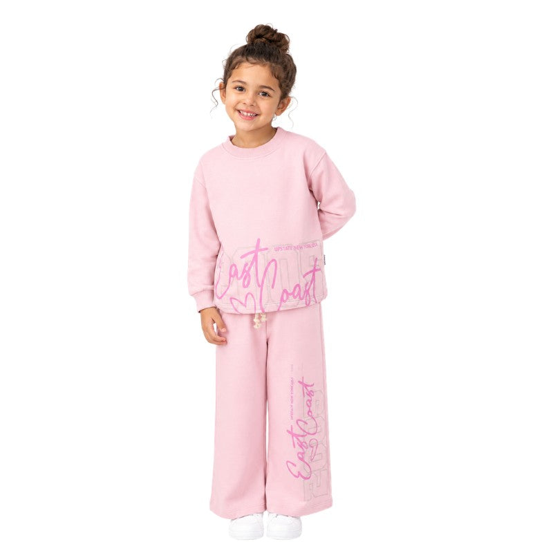 Young girl wearing a graphic tracksuit set 