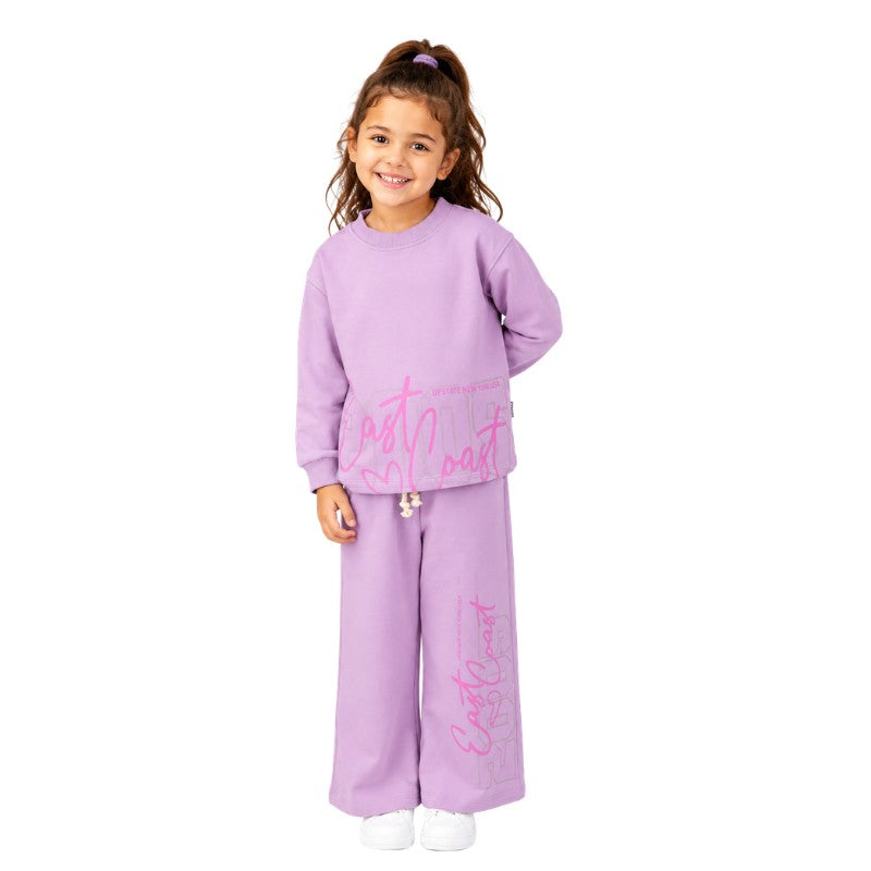 Young girl wearing a graphic tracksuit set 