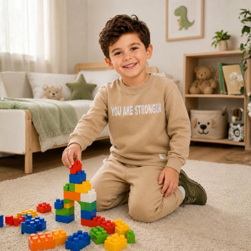Young boy wearing a sweatshirt and matching joggers