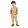 Young boy wearing a sweatshirt and matching joggers