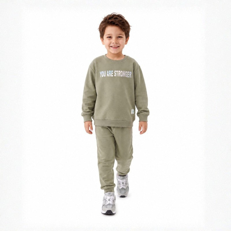 Young boy wearing a sweatshirt and matching joggers