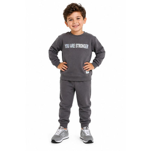 Young boy wearing a sweatshirt and matching joggers
